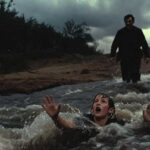 a man trying to save a younger one from drowning.