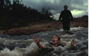 a man trying to save a younger one from drowning.