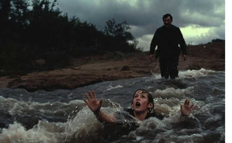 a man trying to save a younger one from drowning.